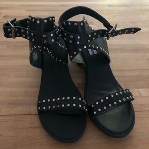 Black strapped short heel leather heels